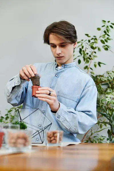 Young artist engages in planting activities while surrounded by lush greenery and art supplies. — Stock Photo
