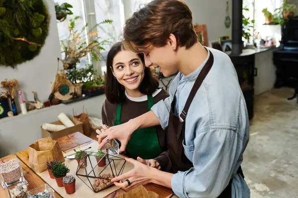 Creative couple collaborate in a bright studio, crafting a unique piece filled with laughter. — Stock Photo