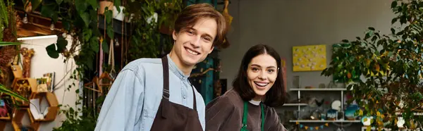 Creative couple engage joyfully in their art studio, surrounded by greenery and creative energy. — Stock Photo