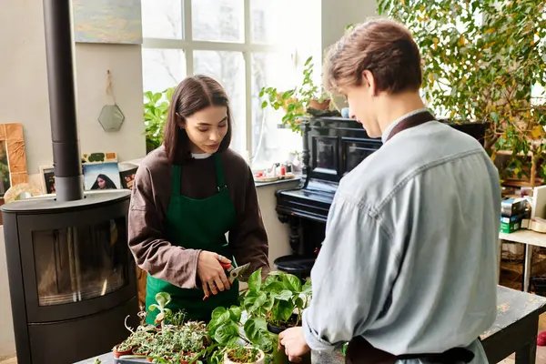 Young couple nurture plants amidst artistic elements in a vibrant studio. — Stock Photo