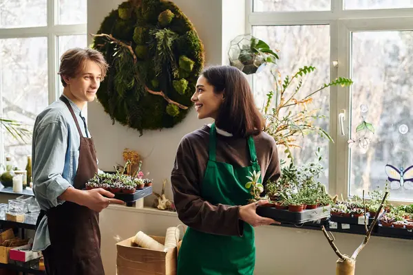 Creative couple joyfully nurture plants in a vibrant, life filled art studio. — Stock Photo