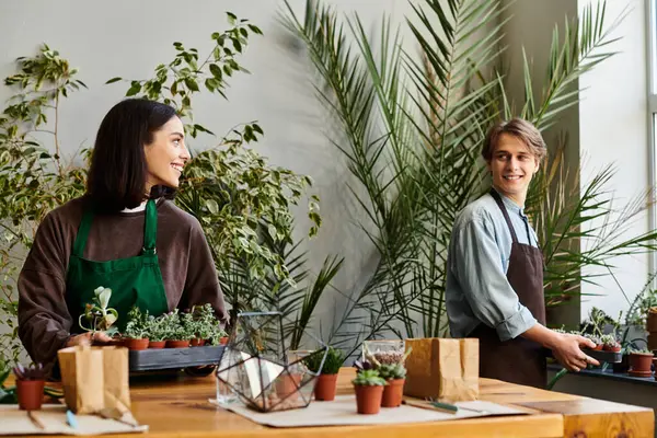 Creative couple engage joyfully in a vibrant art studio surrounded by lush plants and creative energy — Stock Photo
