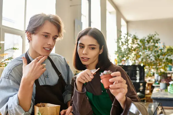 Creative couple engage in a lively discussion while nurturing their creative ideas using plants. — Stock Photo