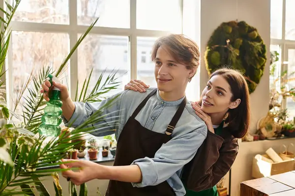 Creative couple create imaginatively amid plants and art supplies, expressing their creativity. — Stock Photo