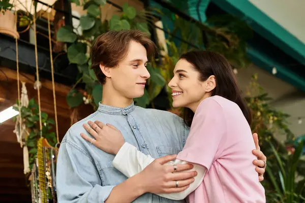 Loving couple express joy and connection in a vibrant art studio filled with creativity. — Stock Photo