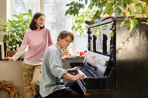 Young couple express creativity in an art studio filled with vibrant plants and music. — Stock Photo