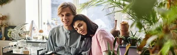 A couple finds inspiration in their art studio filled with plants and supplies. — Stock Photo