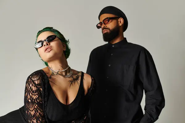 Young couple poses confidently in a trendy studio, showcasing vibrant styles and accessories. — Stock Photo