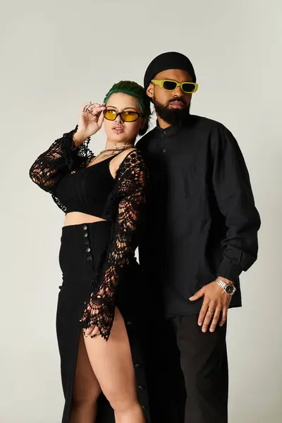A multicultural couple poses confidently in trendy sunglasses, showcasing their unique style. — Stock Photo