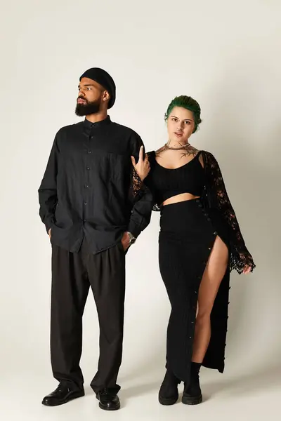 Young couple poses confidently in trendy outfits, highlighting their unique style and diversity. — Stock Photo