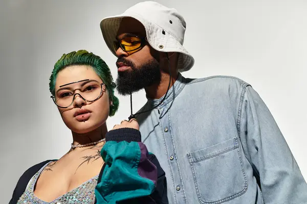 Young couple showcases their unique style in a modern studio setting, exuding confidence and charm. — Stock Photo