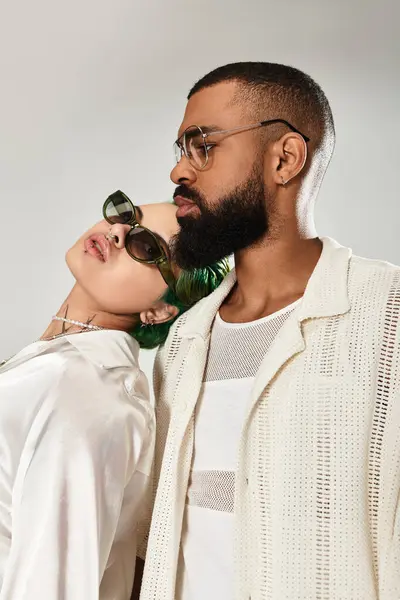 A stylish couple shows off their unique style in a trendy studio, radiating confidence. — Stock Photo