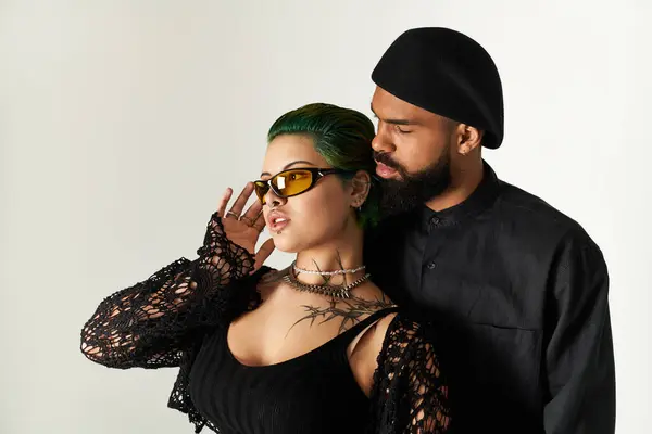 A fashionable young couple showcases their unique style in a studio setting, exuding confidence. — Stock Photo