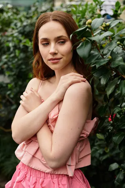 A young woman finds peace among thriving plants in a beautiful greenhouse. — Stock Photo