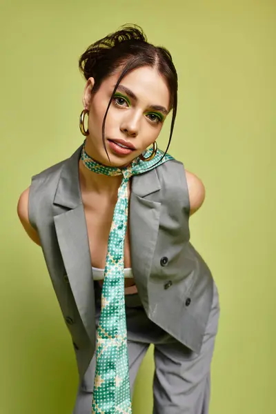 Young woman flaunts her fashion with a trendy outfit and bold green accessories while posing. — Stock Photo