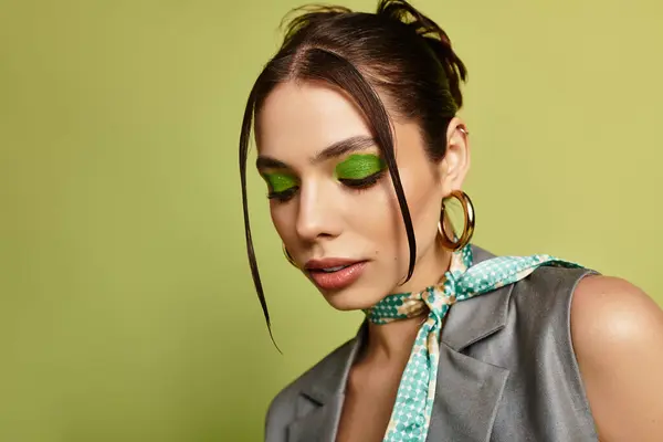 This portrait showcases a young woman with bold green eye makeup and elegant accessories. — Stock Photo