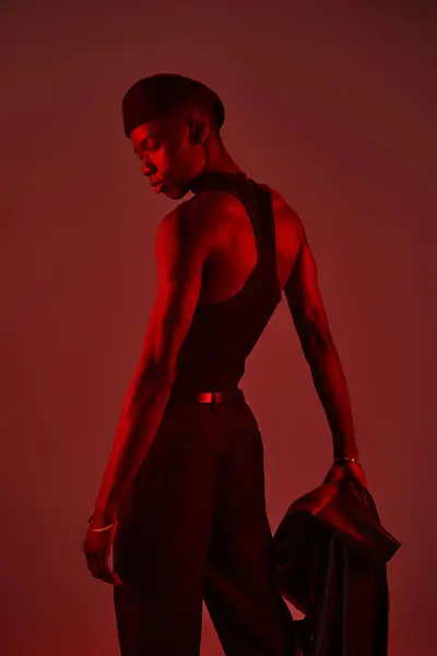 A stylish young man flaunts his vibrant fashion sense in a confident studio pose. — Stock Photo