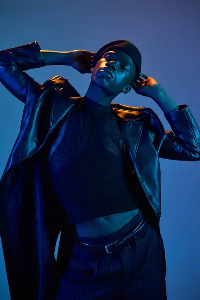 A young african american man displays his vibrant style in a dynamic pose, radiating confidence. — Stock Photo