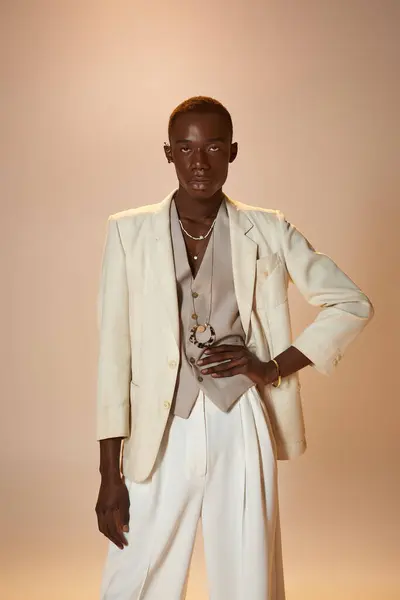 A young african american man exudes charisma in a stylish tailored blazer and elegant accessories. — Stock Photo