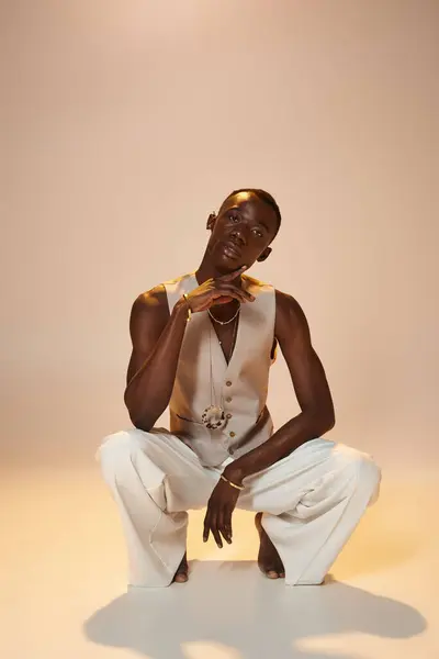 Stylish young man confidently poses in fashion forward attire, exuding charm and charisma. — Stock Photo
