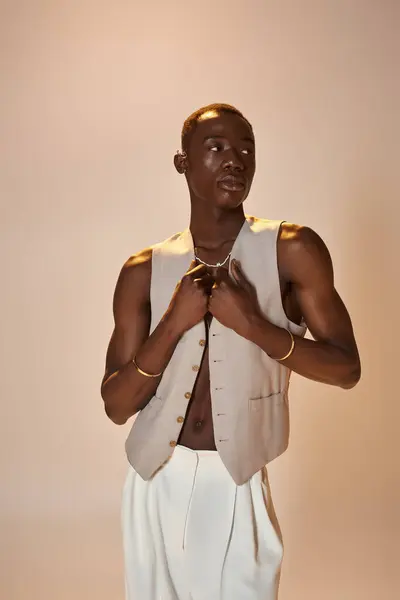 A young african american man showcases contemporary fashion while striking an engaging pose. — Stock Photo