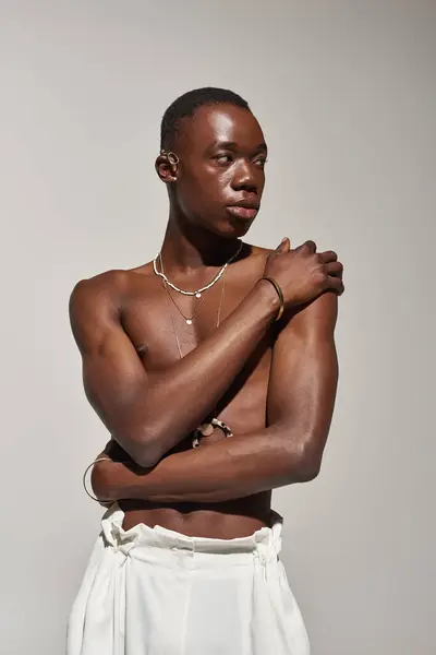 Confident African American man showcases an artistic style in a minimalist setting. — Stock Photo