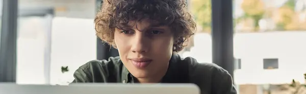 Young person focused on work in a bright, stylish office setting. — Stock Photo