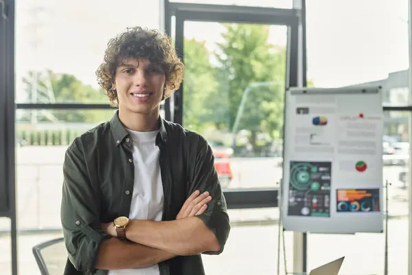 A young professional stands confidently in a contemporary office, emphasizing commitment to work. — Stock Photo