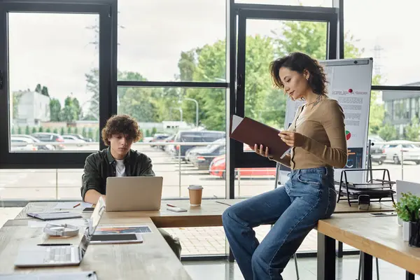Two professionals work in a bright, spacious office environment. — Stock Photo