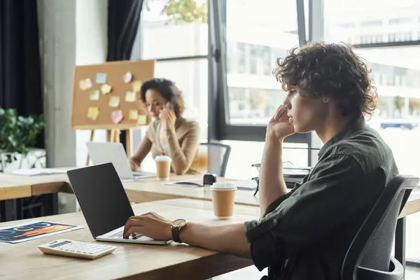 Two office workers focus on their tasks, demonstrating dedication and productivity. — Stock Photo