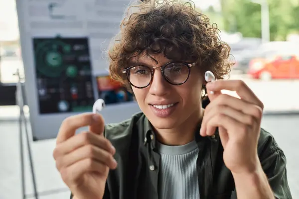 Young individual showcases dedication while showcasing technology within a contemporary workspace. — Stock Photo