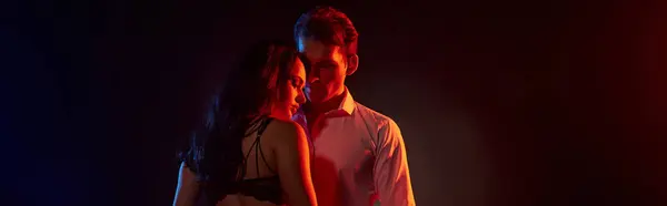 Um casal compartilha um momento íntimo, cercado por cores encantadoras. — Fotografia de Stock