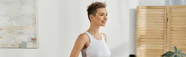Smiling woman exudes confidence and body positivity while standing gracefully indoors. — Stock Photo