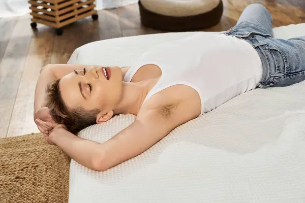A beautiful young woman lies peacefully on a bed, showcasing body positivity and confidence. — Stock Photo