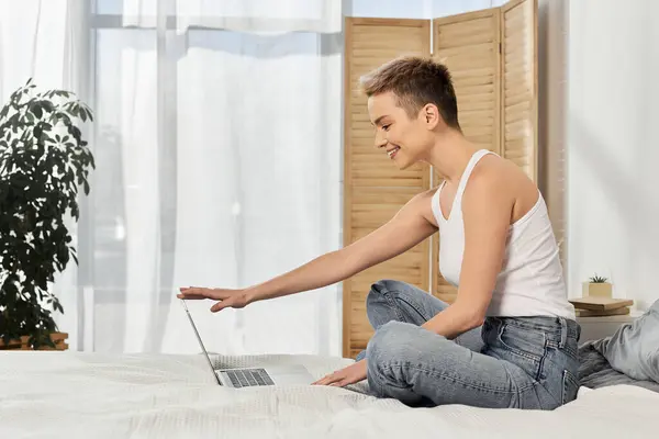 A young woman joyfully types on her laptop, exuding confidence and positivity. — Stock Photo