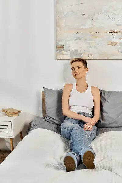 A beautiful young woman sits comfortably on a bed, exuding body positivity and confidence. — Stock Photo