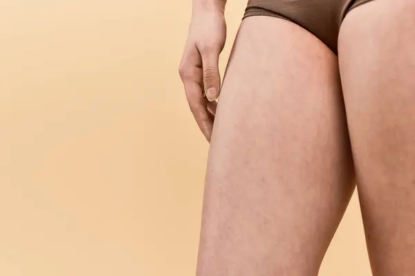 Uma jovem confiante celebra a beleza e a positividade do corpo em um cenário suave. — Fotografia de Stock