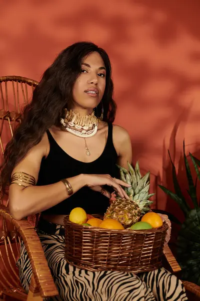 Godendo il calore dell'estate, una giovane donna si rilassa su una sedia chic circondata da frutta fresca. — Foto stock