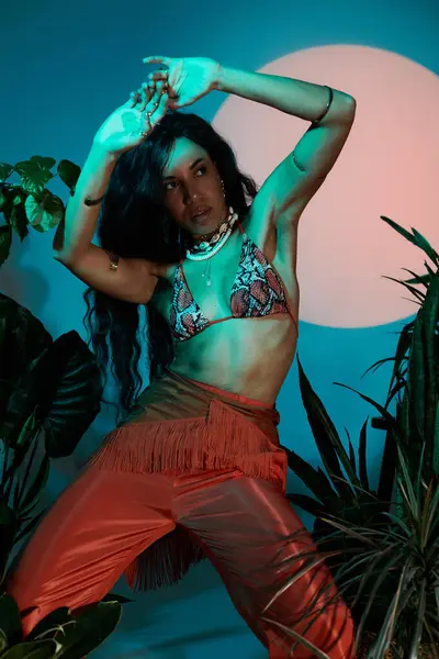 A stylish young woman showcases her summer fashion while posing confidently among tropical plants. — Stock Photo