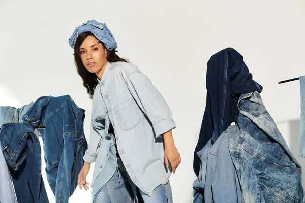 Young woman poses confidently amid stylish denim clothing in a bright summer atmosphere. — Stock Photo