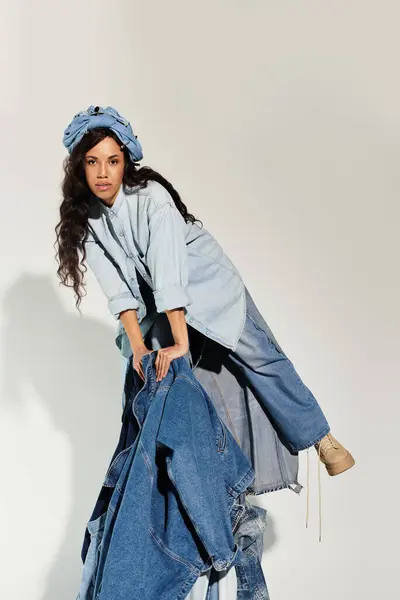A young woman exudes summer vibes in trendy denim layers and a stylish head wrap. — Stock Photo