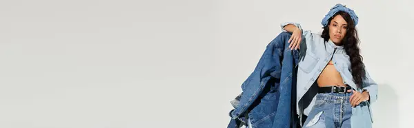 Eine schöne junge Frau umarmt sommerliche Stimmung, während sie in trendiger Jeans posiert. — Stockfoto