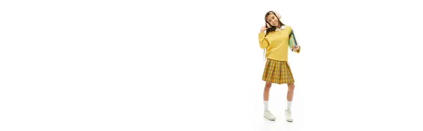 A stylish Asian schoolgirl poses confidently in a vibrant school uniform, radiating charm, banner — Stock Photo