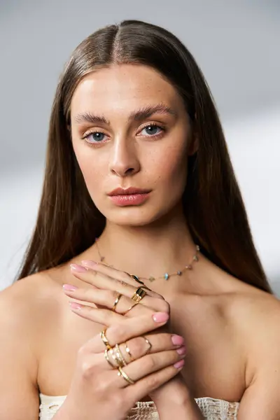 A beautiful young woman showcases stunning jewelry while posing gracefully in summer light. — Stock Photo