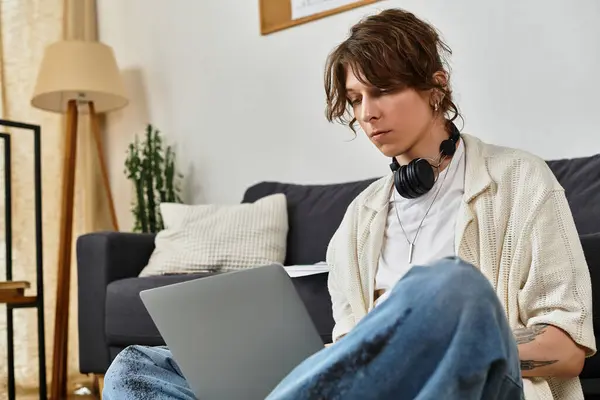 Ein konzentrierter junger Mann studiert an einem ruhigen Nachmittag zu Hause intensiv an seinem Laptop.. — Stockfoto