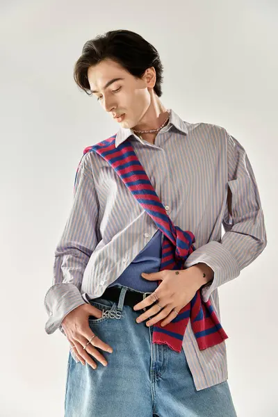 This confident non-binary person showcases their striking outfit and unique style. — Stock Photo