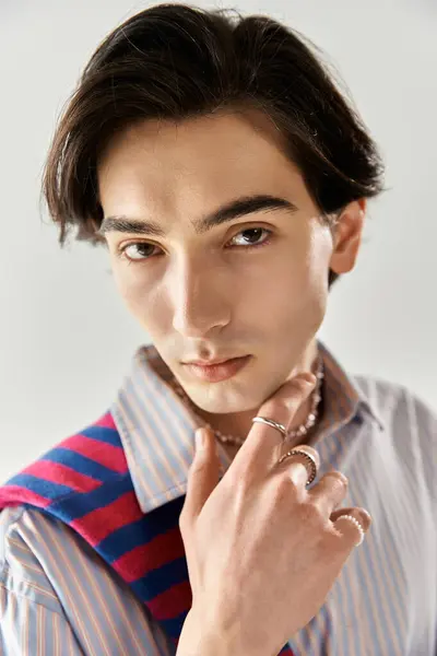 A young non binary person poses confidently in a stylish outfit, reflecting vibrant self-expression. — Stock Photo