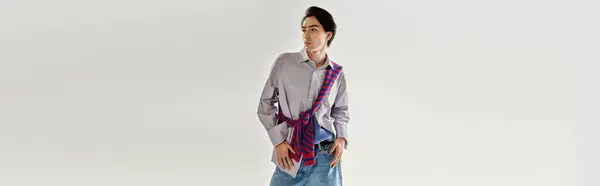 A stylish non-binary person showcases bold accessories in a minimalist setting, banner — Stock Photo