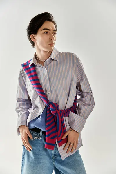 A young non binary person displays confidence and creativity with their unique outfit in a studio. — Stock Photo