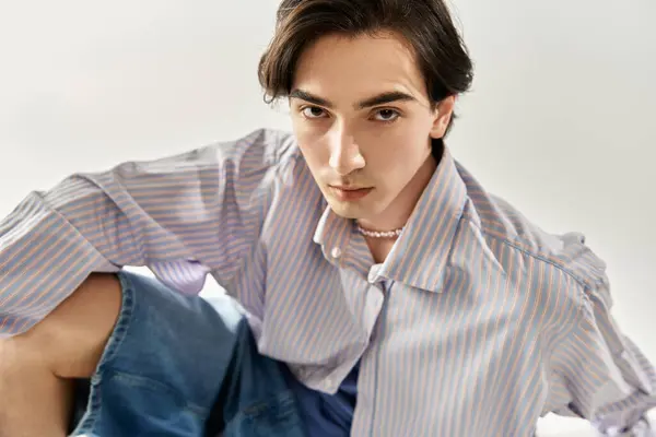 Young non-binary individual exudes style and confidence in a modern environment, embodying pride. — Stock Photo